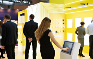 women interacting with stand at exhibition