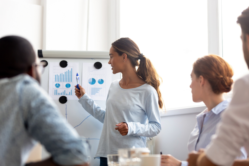 woman evaluating event statistics with clients