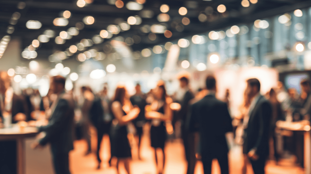 Exhibition space showing a group of people stood talking together